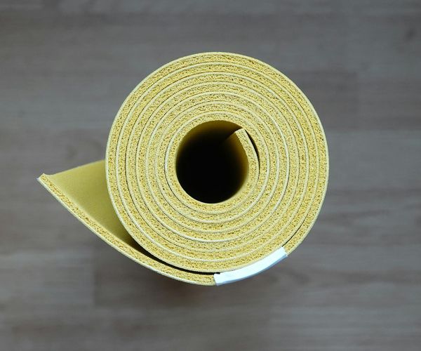 Yoga mat rolled out on the floor, ready for practice.